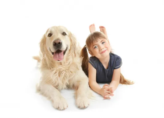 Cute little girl and dog next to each other